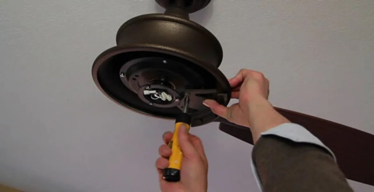 Electrician installing ceiling fan mounting bracket and fixture in Harrisburg, PA