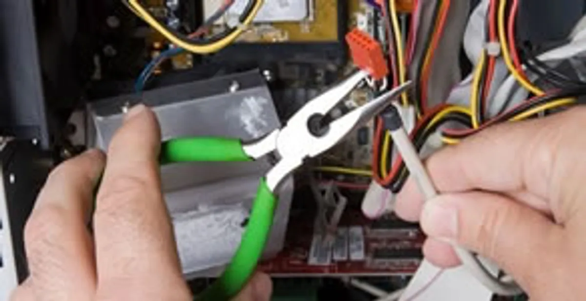 Licensed electrical contractor performing electrical repair with tools in Camp Hill, PA