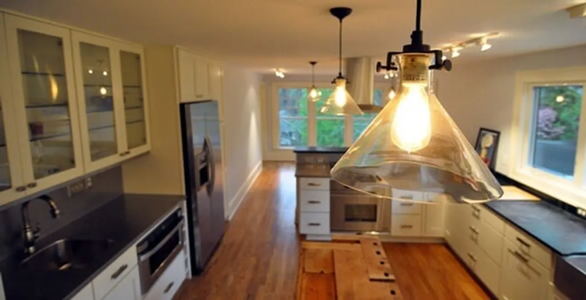 Residential electrician installing modern indoor light fixture in a home in Harrisburg, PA